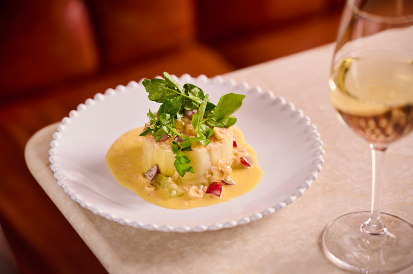 Gourmet plated dish, and a glass of white wine